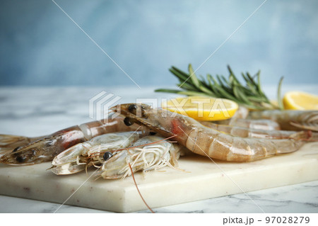 Fresh raw shrimps on marble table, closeup 97028279