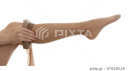 Young woman putting on tights against white background, closeup Young woman putting on tights against white background, closeup 97028529