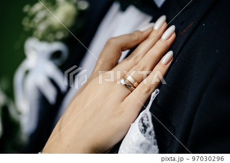 Gold rings of newlyweds, wedding accessories, rings close-up. Gold rings of newlyweds, wedding accessories, rings close-up. 97030296