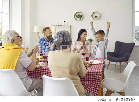Happy mother, father, grandparents and children enjoying lunch and having fun together 97030867