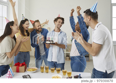 Group of happy, cheerful, excited people having fun at a birthday party of their friend 97030870