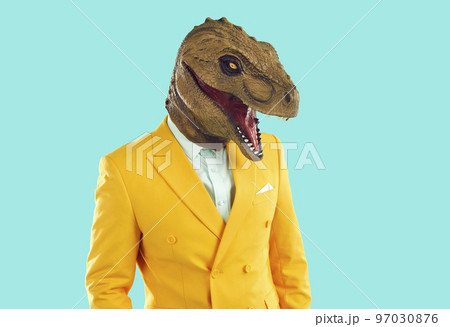 Half length portrait of eccentric man with dinosaur head mask Half length portrait of eccentric man with dinosaur head mask 97030876