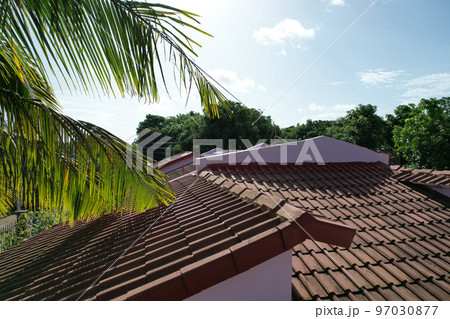 Red house roof on blue sky background 97030877