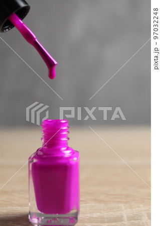 nail polish lilac pink close-up with a brush and a drop of varnish on the end. Nail art. Art Beauty Self Care 97032248