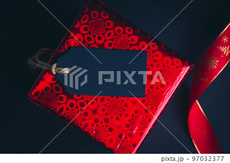 New Year's gift on a black background. Buying gifts The price tag on the New Year's box. 97032377