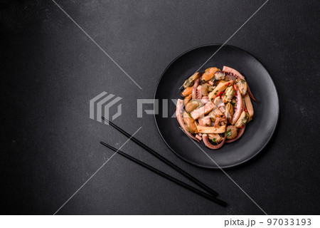Delicious pickled seafood salad or cocktail on a black plate 97033193