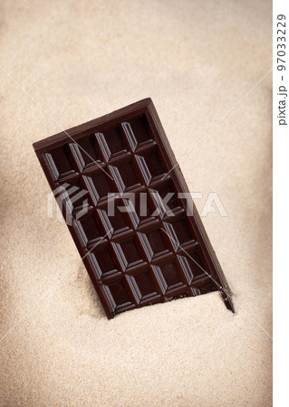 bar of dark chocolate lies in sugar, chocolate abuse and addiction concept, body and dental care bar of dark chocolate lies in sugar, chocolate abuse and addiction concept, body and dental care 97033229