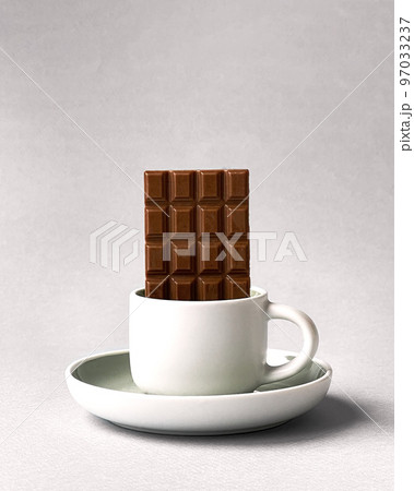 Cup of delicious thick drinkable hot chocolate with pure dark chocolate bars. Bowl with dark chocolate bar isolated on white background and copy space. Cup of delicious thick drinkable hot chocolate with pure dark chocolate bars. Bowl with dark chocolate bar isolated on white background and copy space. 97033237