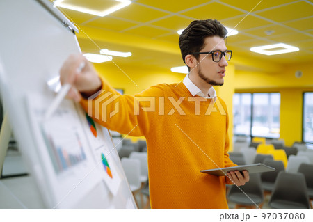 Young man leader, presenter, make a business presentation at a conference in the office. 97037080