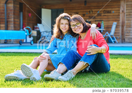 Portrait of happy mom and teenage daughter looking at camera Portrait of happy mom and teenage daughter looking at camera 97039578