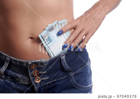 Woman wearing jeans shorts with Brazilian money 97040379