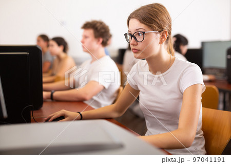 Portrait of interested teen girl during lesson in computer room of school class 97041191