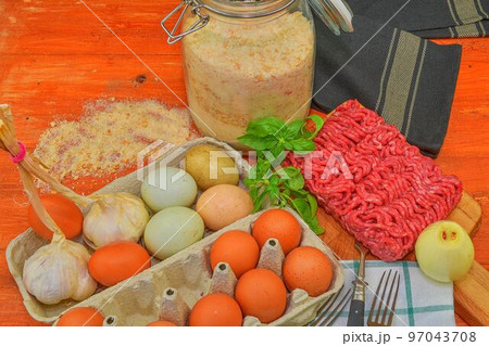 Mince. Ground meat with ingredients for cooking. Mixed minced meat ready to making burgers, fatty's, meaetballs. Food photography. Culinary concept. Minced meat recipe Mince. Ground meat with ingredients for cooking. Mixed minced meat ready to making burgers, fatty's, meaetballs. Food photography. Culinary concept. Minced meat recipe 97043708