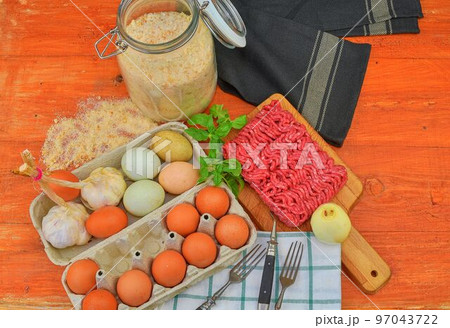 Mince. Ground meat with ingredients for cooking. Mixed minced meat ready to making burgers, fatty's, meaetballs. Food photography. Culinary concept. Minced meat recipe Mince. Ground meat with ingredients for cooking. Mixed minced meat ready to making burgers, fatty's, meaetballs. Food photography. Culinary concept. Minced meat recipe 97043722