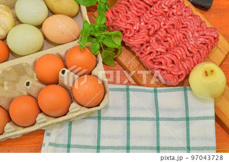 Minced meat, eggs, garlics and onion. Mixed minced meat ready to making burgers, fatty's, meaetballs. Food photography. Culinary concept. Minced meat recipe Minced meat, eggs, garlics and onion. Mixed minced meat ready to making burgers, fatty's, meaetballs. Food photography. Culinary concept. Minced meat recipe 97043728