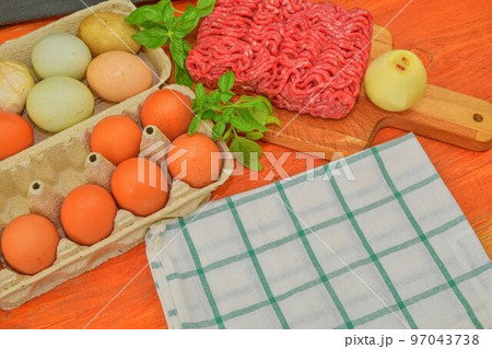 Minced meat, eggs, garlics and onion. Mixed minced meat ready to making burgers, fatty's, meaetballs. Food photography. Culinary concept. Minced meat recipe Minced meat, eggs, garlics and onion. Mixed minced meat ready to making burgers, fatty's, meaetballs. Food photography. Culinary concept. Minced meat recipe 97043738