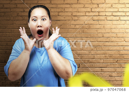 Asian fat overweight woman with a shocked expression Asian fat overweight woman with a shocked expression 97047068