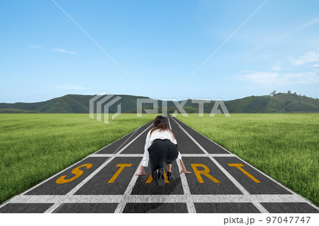 Asian businesswoman in start position ready to run on the track Asian businesswoman in start position ready to run on the track 97047747