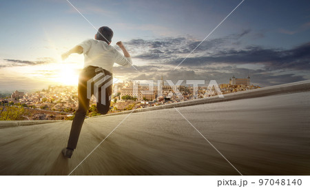 Rear view of Asian businessman running 97048140