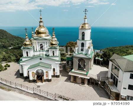 Christian church in the mountains above the sea. Temple of the Holy Archangel Michael in Oreanda. The southern coast of Crimea. Aerial view Christian church in the mountains above the sea. Temple of the Holy Archangel Michael in Oreanda. The southern coast of Crimea. Aerial view 97054390