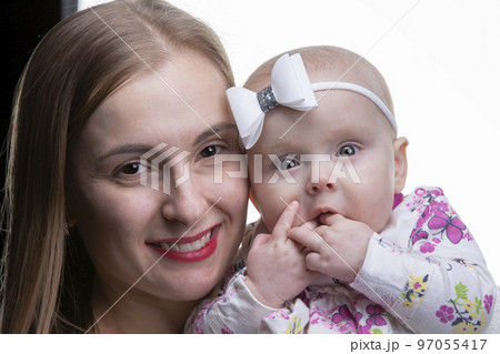 Portrait of a beautiful mother and little daughter. Portrait of a beautiful mother and little daughter. 97055417