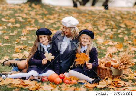 A big family on a picnic in the fall in a nature park. Happy people in the autumn park 97055831