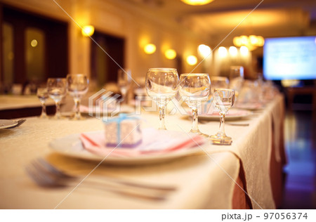 Beautiful table setting with crockery and flowers for a party, wedding reception or other event. 97056374