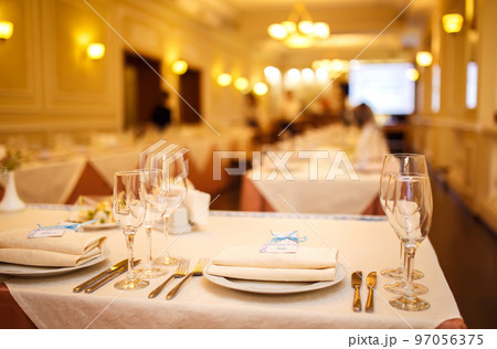 Beautiful table setting with crockery and flowers for a party, wedding reception or other event. Beautiful table setting with crockery and flowers for a party, wedding reception or other event. 97056375