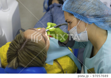 Dental health concept. female mouth on treatment in a dental clinic, 97057689