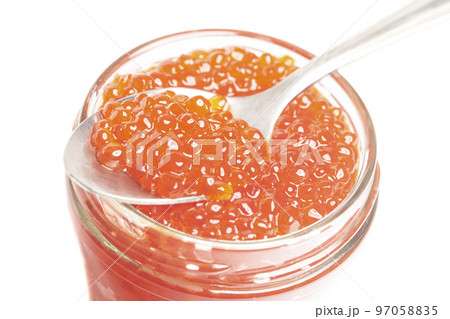 Glass jar and spoon with delicious red caviar isolated on white background. Glass jar and spoon with delicious red caviar isolated on white background. 97058835