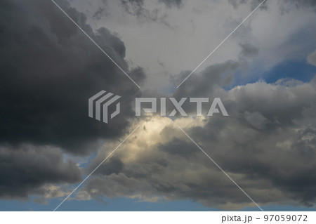 rain clouds in the sky with a blue sky and sunlight rain clouds in the sky with a blue sky and sunlight 97059072