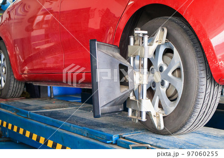 Car wheel alignment in progress at auto repair service centre 97060255