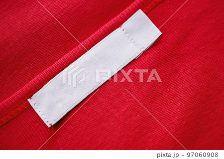Blank white clothes tag label on new red shirt Blank white clothes tag label on new red shirt 97060908