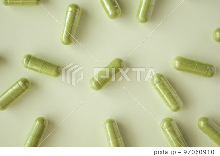 Herbal medicine capsules on white background 97060910