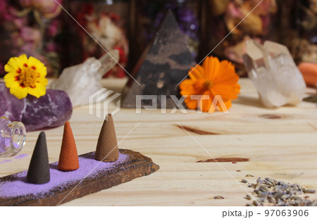 Incense Cones on Stone Slab With Crystals and Flowers 97063906