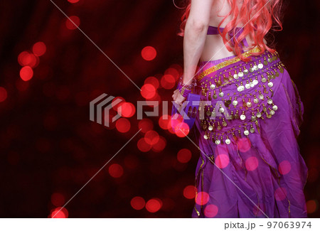 Belly Dancer wearing purple dance costume close up with bokeh Belly Dancer wearing purple dance costume close up with bokeh 97063974