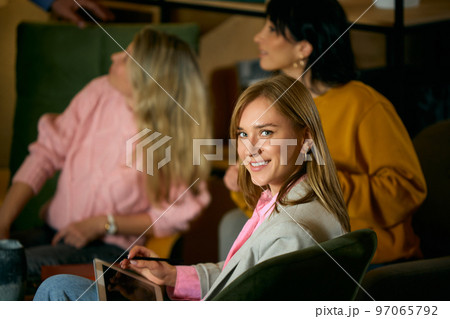 Cheerful woman, employee, trainee attending business meeting, training class at the office, indoors. Education. Concept of business, brainstorming, conference Cheerful woman, employee, trainee attending business meeting, training class at the office, indoors. Education. Concept of business, brainstorming, conference 97065792