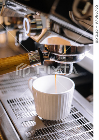 Macro shot of preparing espresso on professional coffee machine 97066765