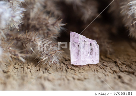 Kunzite Crystal Healing Stone on Wood Background 97068281