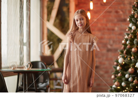 pretty girl standing by the Christmas tree. pretty girl standing by the Christmas tree. 97068327