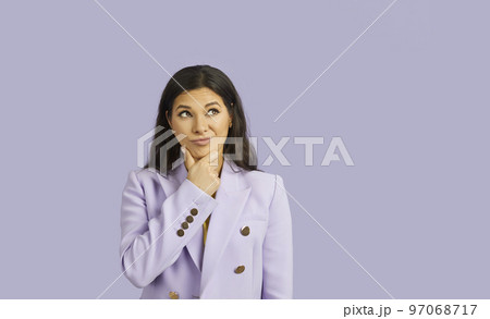 Portrait of beautiful woman with doubtful facial expression isolated on pastel purple background. 97068717