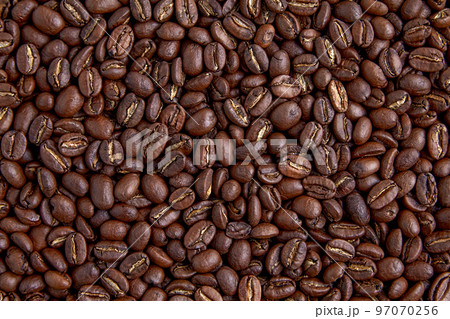 Background of randomly scattered roasted coffee beans Background of randomly scattered roasted coffee beans 97070256