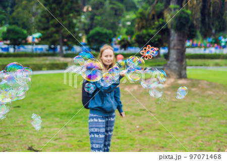 Young woman feeding an African Sacred ibis 97071468