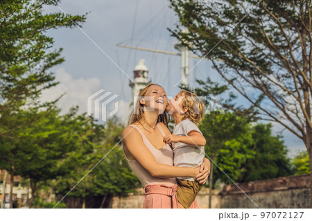 Mom and son on background of Fort Cornwallis in Georgetown, Penang, is a star fort built by the British East India Company in the late 18th century, it is the largest standing fort in Malaysia Mom and son on background of Fort Cornwallis in Georgetown, Penang, is a star fort built by the British East India Company in the late 18th century, it is the largest standing fort in Malaysia 97072127