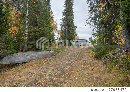 camping caravan near river autumn fall landscape along Ammarnas National Park in Lapland Sweden 97073472