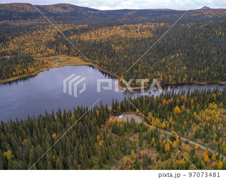 aerial view camping caravan near river autumn fall landscape along Ammarnas National Park in Lapland Sweden aerial view camping caravan near river autumn fall landscape along Ammarnas National Park in Lapland Sweden 97073481