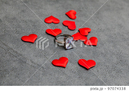 Will you marry me. Wedding ring many red hearts on concrete stone grey background. Engagement marriage proposal wedding concept. St. Valentine's Day postcard. Banner on valentines day Will you marry me. Wedding ring many red hearts on concrete stone grey background. Engagement marriage proposal wedding concept. St. Valentine's Day postcard. Banner on valentines day 97074338