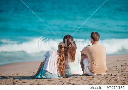 Portrait of family of three on the beach 97075585