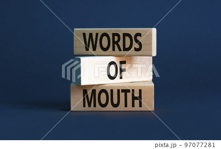 Words of mouth symbol. Concept words Words of mouth on wooden blocks on a beautiful grey table grey background. Business, finacial and words of mouth concept. Copy space. 97077281