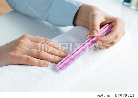 Woman using nail file and create nails shape 97079611